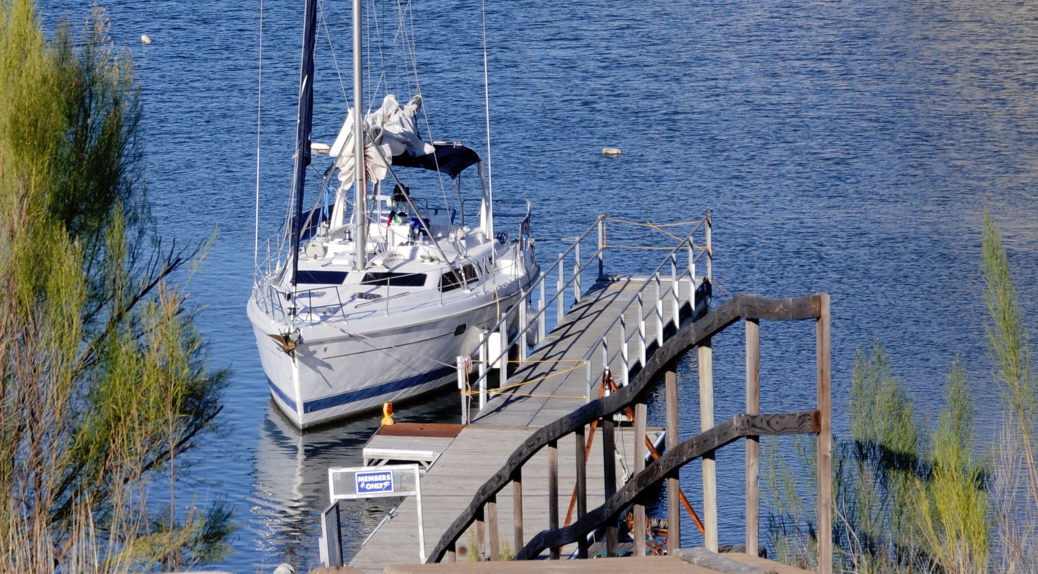 yacht anchored next to a pier